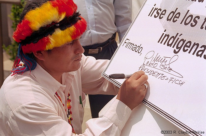 Presidents of the Amazon Federations of Ecuador and supporters held a press conference/demonstration outside the Galleria offices of Burlington Resources to reject officially any oil exploration or development activity in the Block 24 area of the Ecuadorian Amazon. Pablo Tsere, President of FICSH, the Shuar Federation, signs a symbolic "eviction notice" ordering Burlington to cease and desist all oil-related activities and leave indigenous lands.