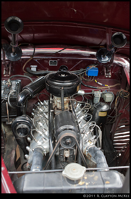 By comparison with the simple elegance of the Bugatti, here's a lovingly cared-for 191 Lincoln Continental.  It's a V12; note the airhorns mounted on the underside of the hood.  !!!